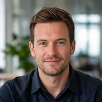 Professional portrait of a Swedish author in smart casual attire, suitable for an editorial website.